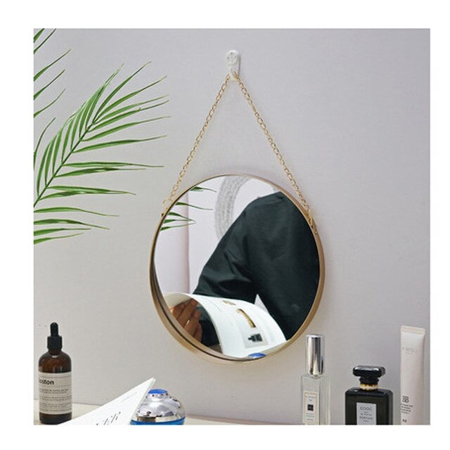 Gold mirror with chain strap.