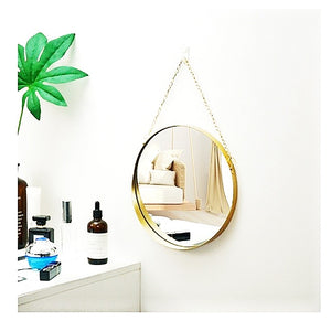 Gold mirror with chain strap.